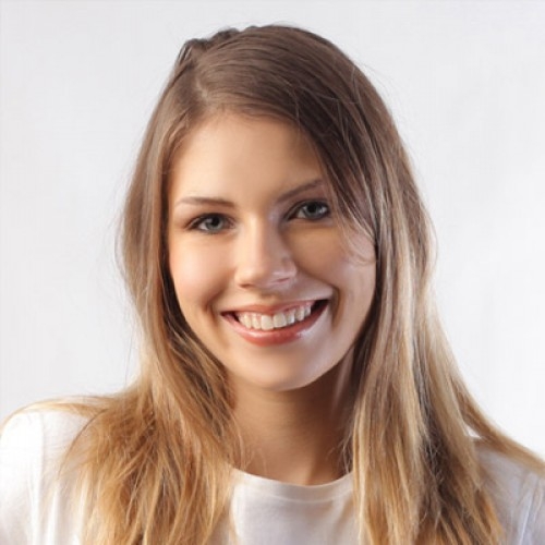 A beautiful Lady is smiling earing a white T-shirt